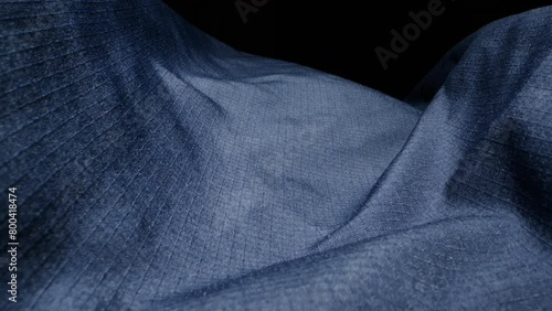Waterproof clothing for tourism. Blue cloth texture with water drop close-up macro. Repellent waterproof breathable fabrics. Innovation waterproofing material test photo