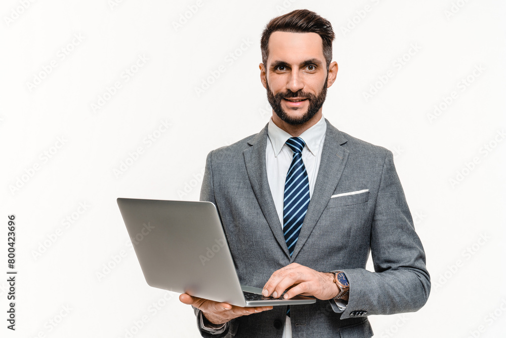 Successful young businessman working on laptop isolated over white background. Confident manager banker employee watching webinars, teleworking, consulting customers remotely Successful young businessman working on laptop isolated over white background. Confident manager banker employee watching webinars, teleworking, consulting customers remotely