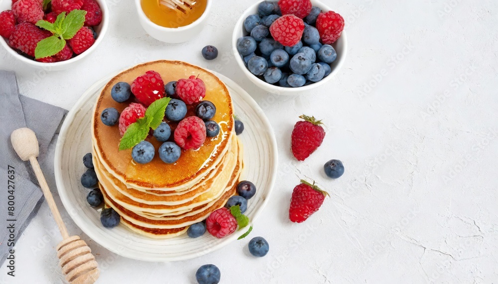 pancakes decorated with raspberries and blueberries and honey pancakes decorated with raspberries and blueberries and honey