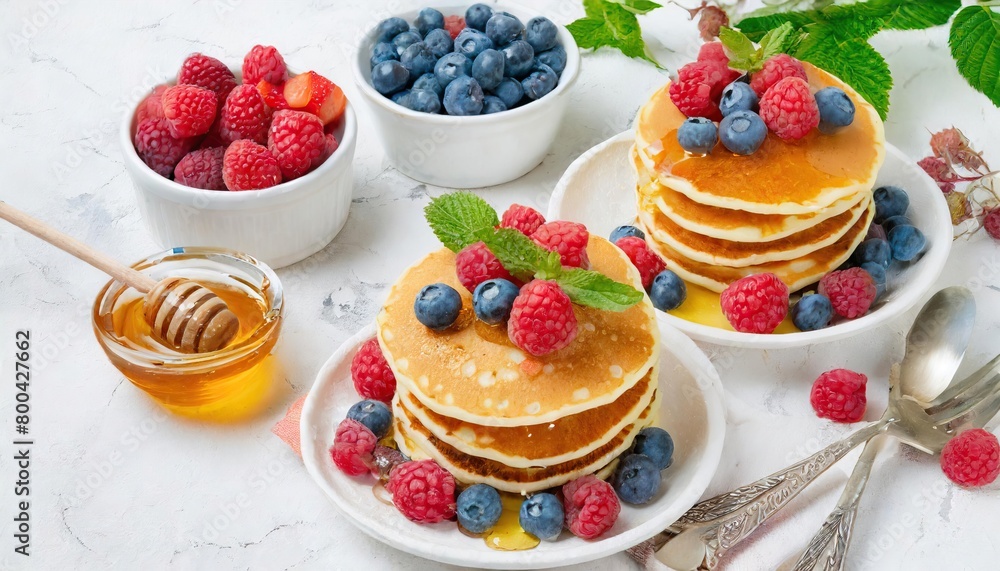 pancakes decorated with raspberries and blueberries and honey pancakes decorated with raspberries and blueberries and honey