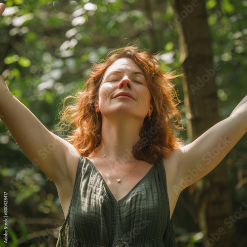 Portrait of determinated woman rising her arms up in the air in sign of self confidence