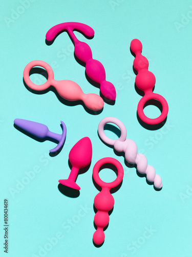 sex toys background. anal plugs and dildo over blue backdrop © Nik_Merkulov