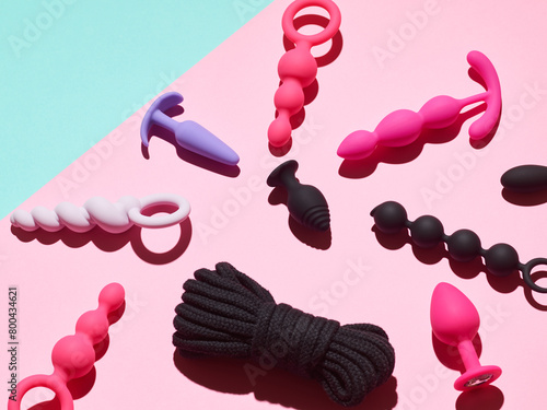 sex toys background. anal plugs and dildo over pink backdrop © Nik_Merkulov