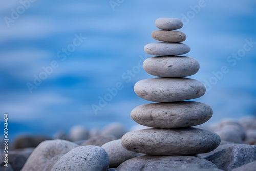 Stacked rounded stones in blue setting exude balance and tranquility  inviting contemplation of nature