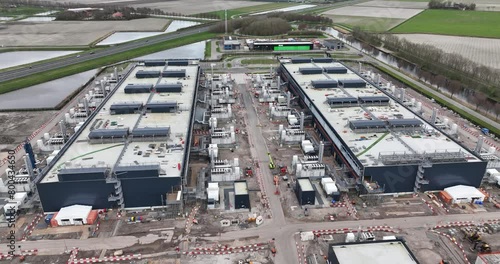 Internet infestructure. Exterioir aerial view on data centers in the dutch Polder, controversial because of massive electricity usage. Aerial drone view on Big tech companies and cloud infrastructure.