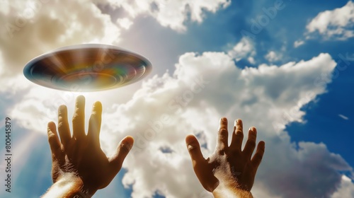 man raising his hands welcoming and worshipping an extraterrestrial flying saucer arriving to planet earth photo