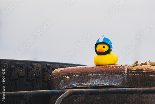 Small yellow rubber duck in motorcycle helmet. Travel symbol, car toy. © Galina Atroshchenko