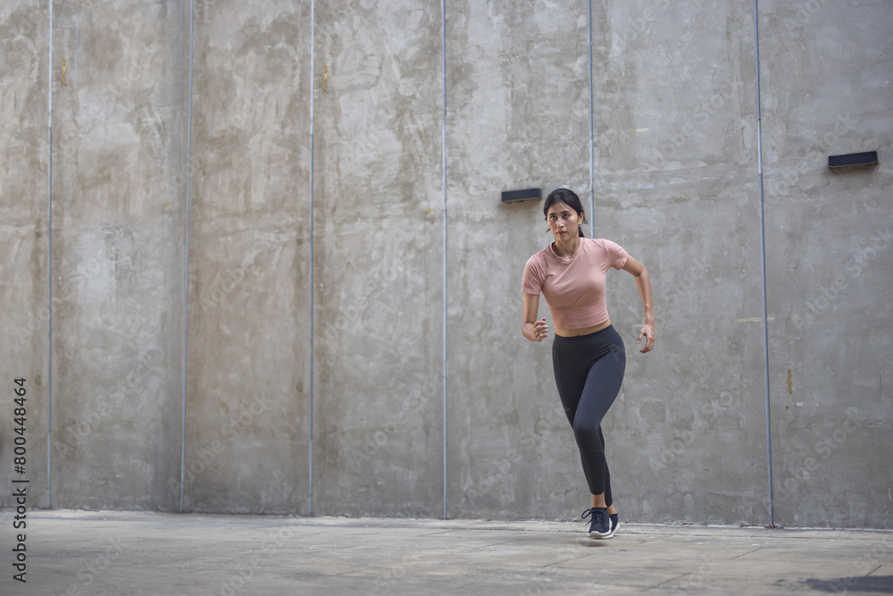 Female urban runner run on the street with copy space Female urban runner run on the street with copy space