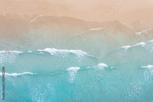 Ocean waves breaking onto a beach. Sandy clean coast. photo