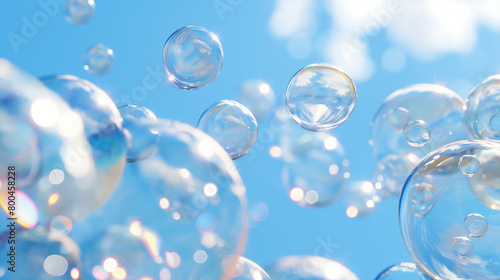 Myriad of transparent soap bubbles floating against a clear blue sky  close-up view