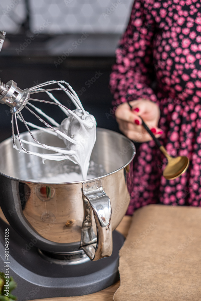 The shiny whisk of a kitchen mixer in action, creating the perfect
