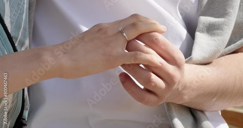 Marriage proposal. Young couple holding hands close-up. Man holding female hand with engagement diamond ring. Romance, love, connection, relationship