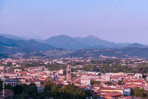 Aerial view of historic medieval walled city of Bergamo seen from Città Alta (Upper Town), Lombardy, Northern Italy, Europe. Alpine landscape of Italian Alps, historical buildings and the towers © Chris