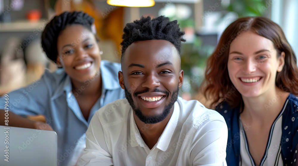 Happy multiracial business team at work looking at camera