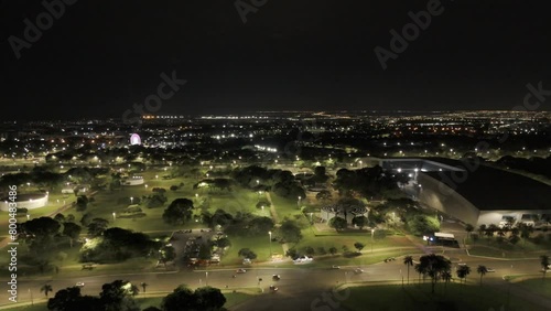 Drone flies over Convention Center Ulysses Guimarães toward Castelinho do Parque da Cidade at night in Brasilia, Brazil photo