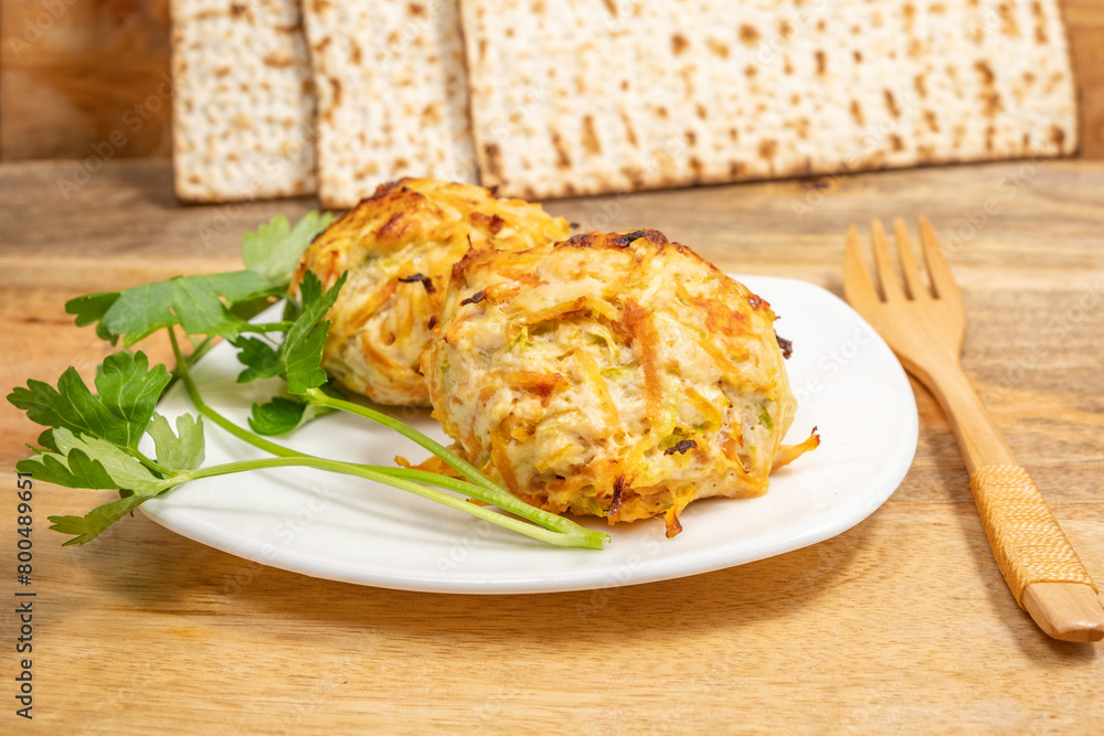 Chicken Vegetables Cutlets served with lettuce leaf, wooden cutlery, matzah piece on ceramic plate for Jewish holiday Pesach. Chicken Vegetables Cutlets served with lettuce leaf, wooden cutlery, matzah piece on ceramic plate for Jewish holiday Pesach.