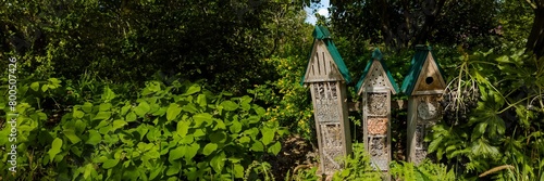 Rustic birdhouses nestled in lush greenery, exemplifying eco-friendly gardening and nature conservation, ideal for Earth Day and International Biodiversity Day themes