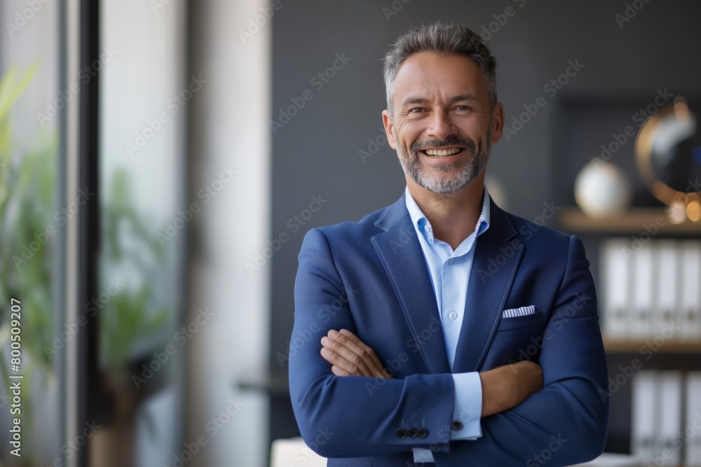 Happy middle aged business man ceo standing in office arms crossed. Smiling mature confident professional executive manager, proud lawyer, businessman leader wearing blue suit Happy middle aged business man ceo standing in office arms crossed. Smiling mature confident professional executive manager, proud lawyer, businessman leader wearing blue suit