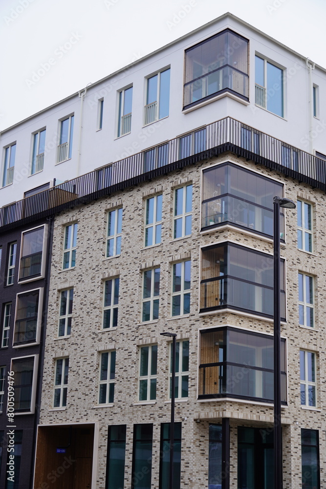 Close up of new modern beige and brown building during the day with no people. Many windows. Tallinn, Estonia, Europe 2024.