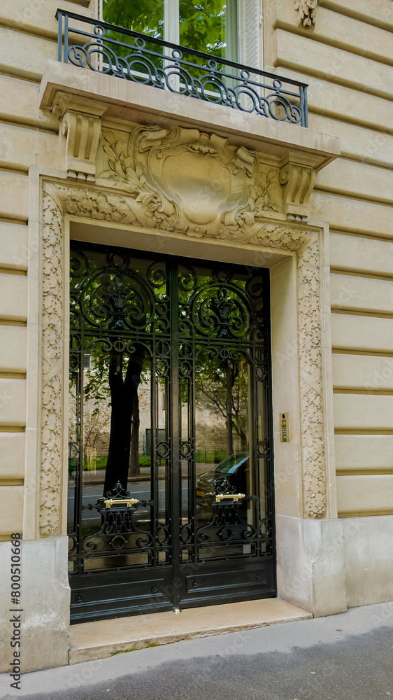 Elegant Parisian doorway with intricate wrought iron gates and ornate stonework, showcasing classic French architecture, ideal for travel and real estate themes Elegant Parisian doorway with intricate wrought iron gates and ornate stonework, showcasing classic French architecture, ideal for travel and real estate themes