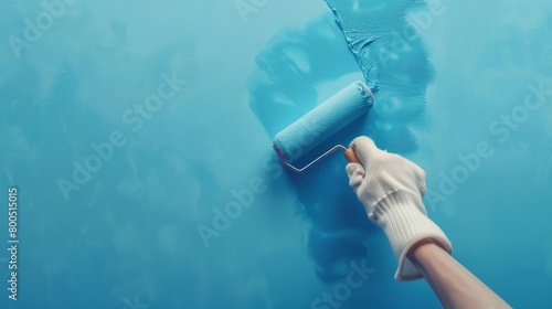 Hand in white gloves with roller painting wall blue, copy space for text on left side, banner design, closeup shot from above, studio lighting, pastel color background, minimal concept, extremely deta photo