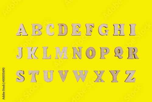 wooden letters of the English alphabet on a yellow background