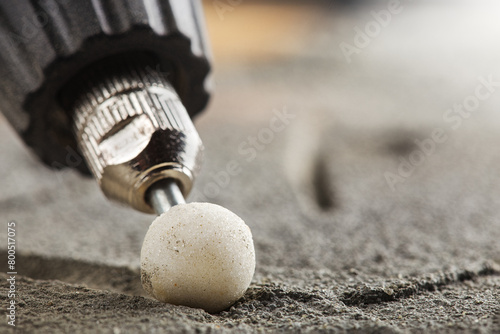 grinding bevel of ceramic tiles by grinding stone using drill.