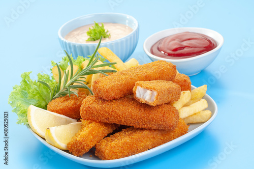 Fried Breaded fish Fingers with salad and condiments 