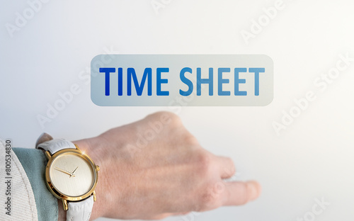 Hand with a clock and an inscription on a light background Time Sheet