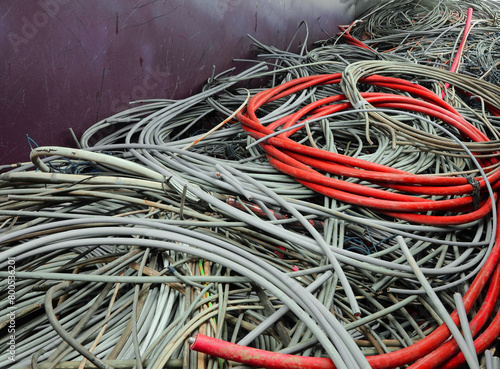 Discarded RED High-Amp Copper Cord Awaits Recycling at Scrap Metal Facility photo