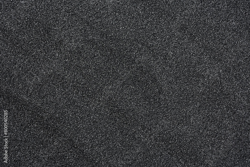 Pile of black quartz sand as background, top view. Crushed quartz. photo