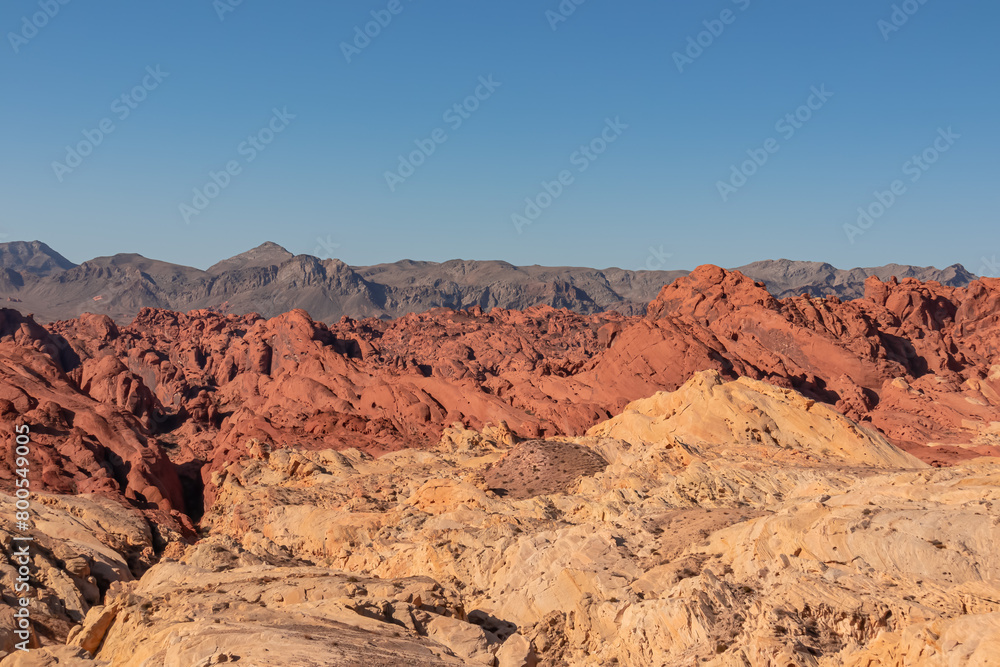Scenic view of from Silica Dome viewpoint overlooking the Valley of Fire State Park in Mojave desert, Nevada, USA. Landscape of Aztek sandstone rock formations. Hot temperature in arid vegetation