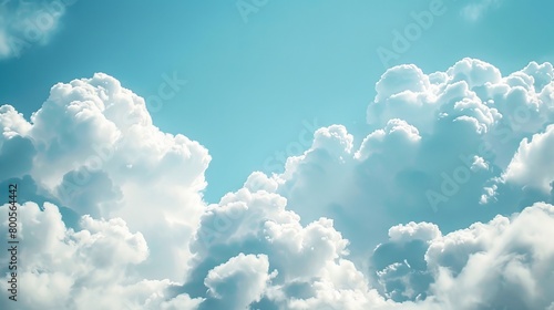 A close-up view of fluffy white cumulus clouds drifting across a clear blue sky.