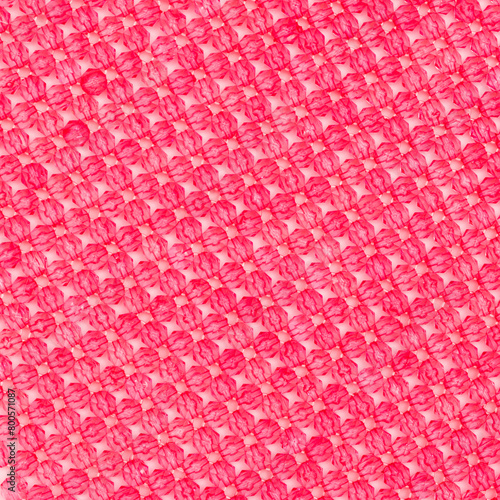 Texture made from acrylic beads on a pink background.