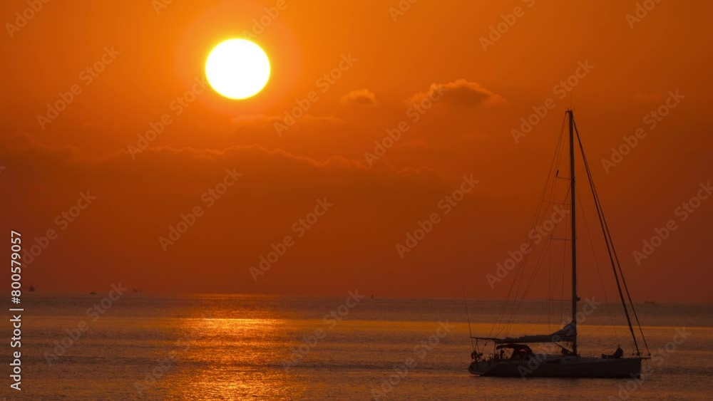 Picturesque peaceful landscape of golden sunset on the seashore. Yacht silhouette floating Picturesque peaceful landscape of golden sunset on the seashore. Yacht silhouette floating