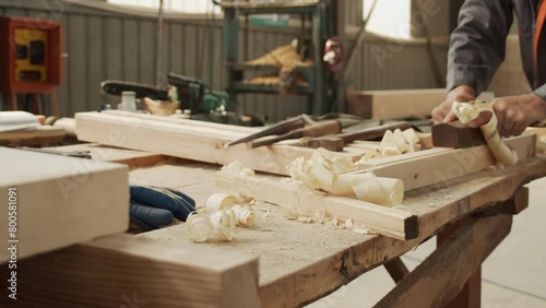A woodworker is hard at work using a plane photo