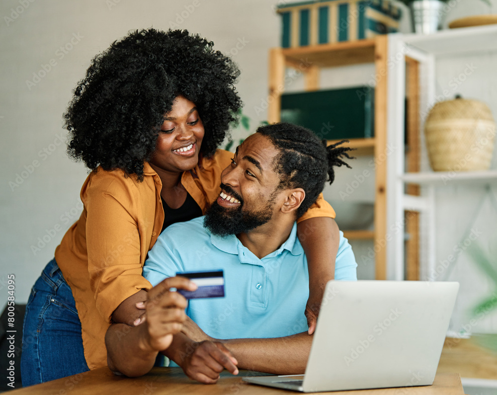 © Lumos sp - couple credit woman laptop shopping card online technology internet payment computer young man love together order happy