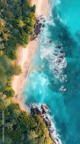 An incredible aerial view of a beach with rocky formations  rich blue ocean waters  and deep green foliage complementing the natural landscape