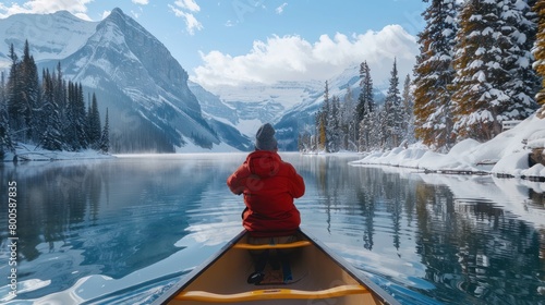 Rear view a male traveler drive a canoe in deep lake in winter season. Generated AI image photo