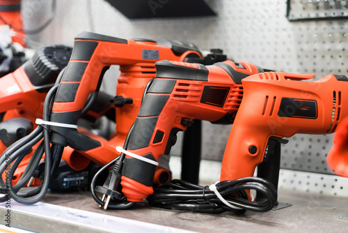 Power tools, drills and hammers of various manufacturers are sold in a hardware store.