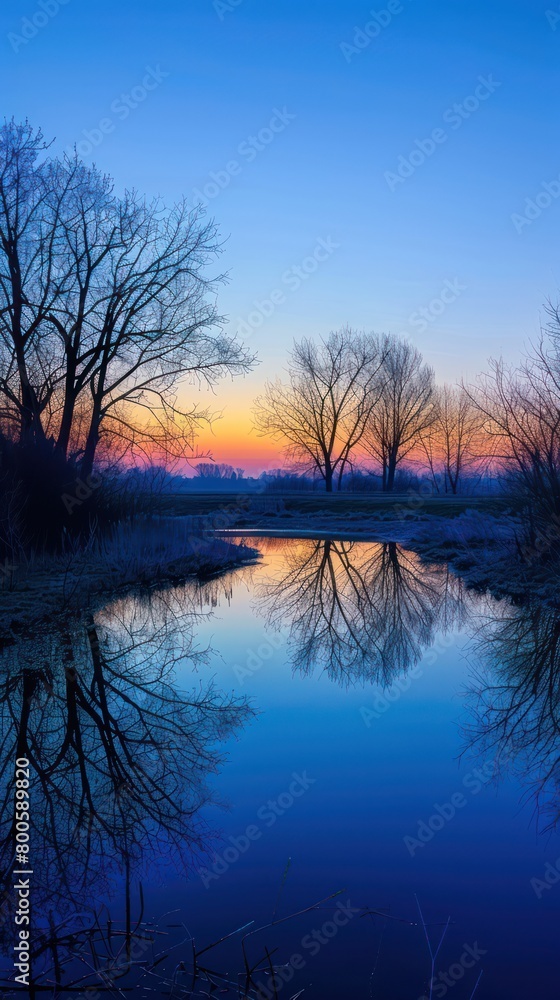 A river calmly mirrors the twilight sky, creating a symphony of blue tones that evoke a sense of tranquility and reflection A river calmly mirrors the twilight sky, creating a symphony of blue tones that evoke a sense of tranquility and reflection