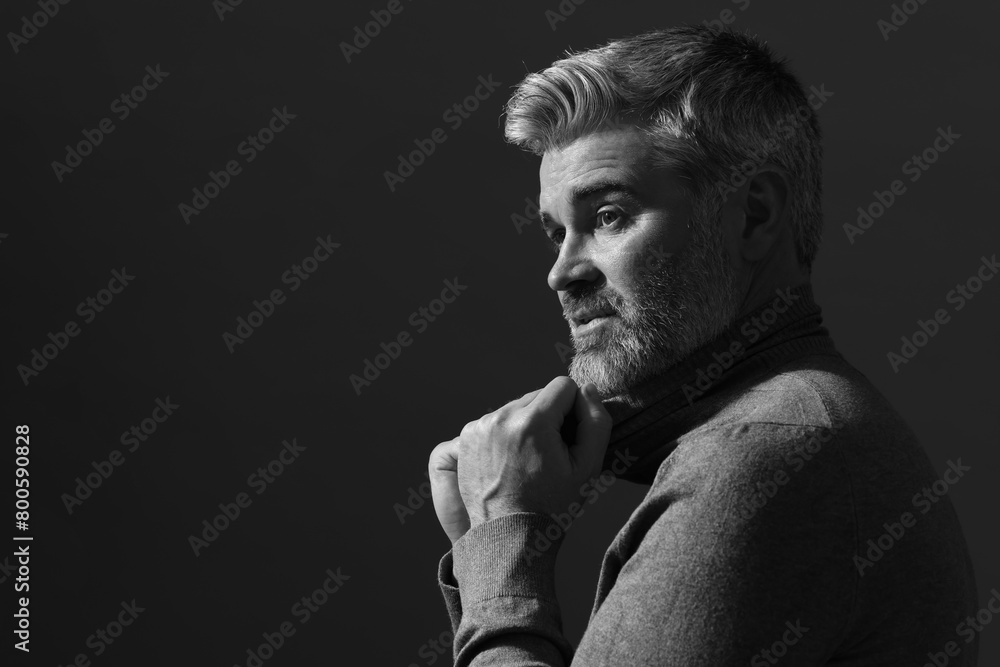 Portrait of handsome man on dark background, space for text. Black and white effect