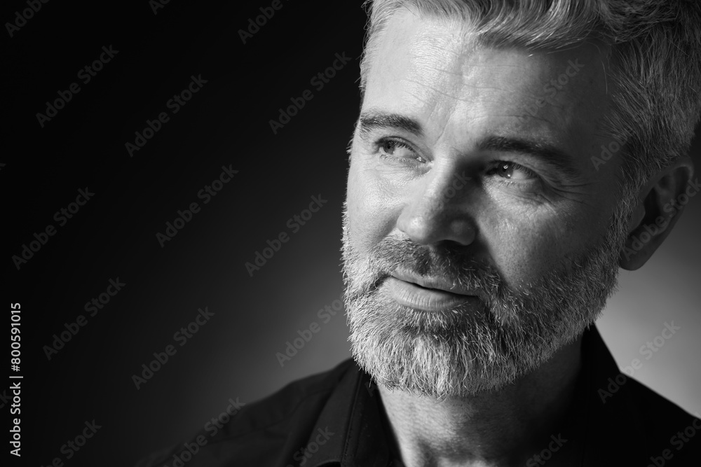 Portrait of handsome man on dark background, space for text. Black and white effect Portrait of handsome man on dark background, space for text. Black and white effect