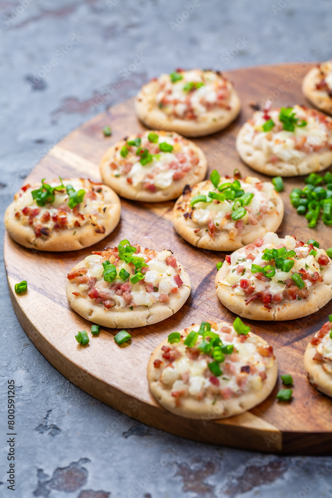 Small French dish tarte flambee cream cheese, bacon and onions