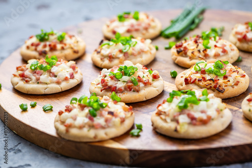 Small French dish tarte flambee cream cheese, bacon and onions photo