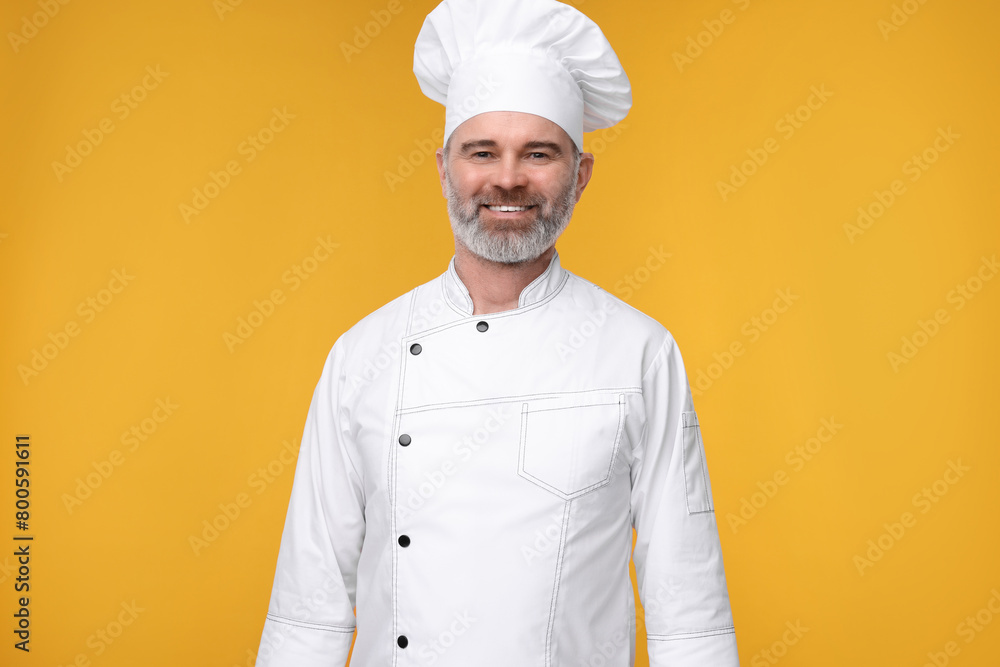 Happy chef in uniform on orange background Happy chef in uniform on orange background