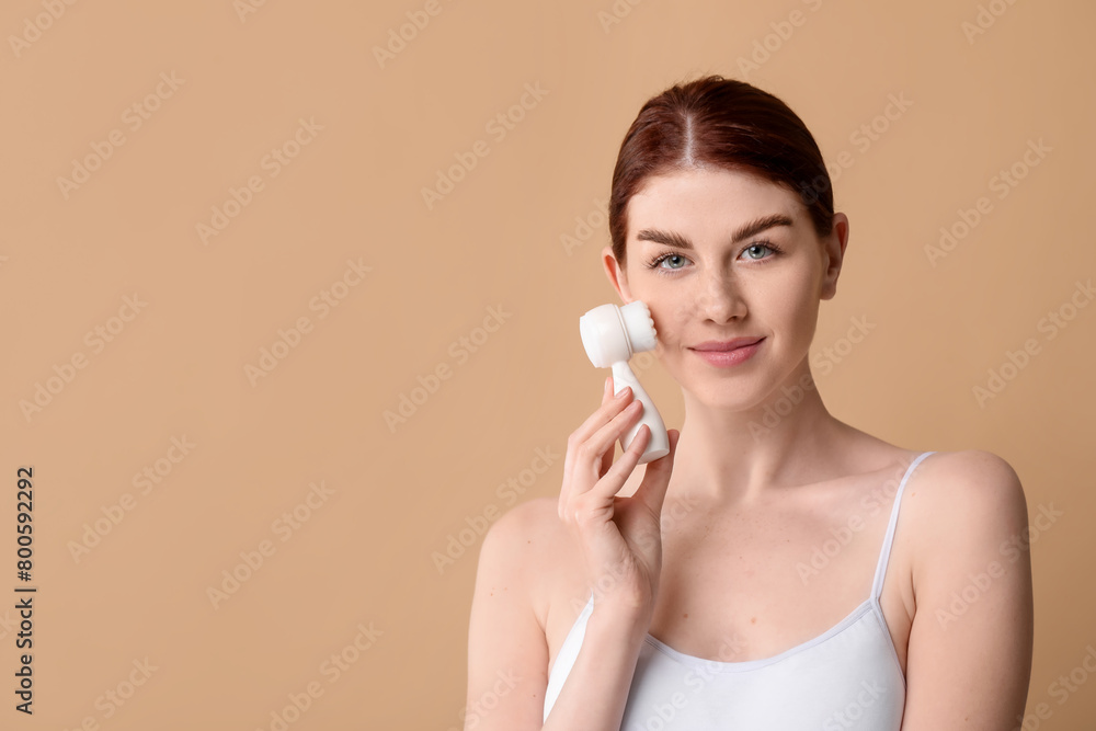 Washing face. Young woman with cleansing brush on beige background, space for text Washing face. Young woman with cleansing brush on beige background, space for text
