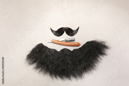 Artificial moustache, beard and straight razor on light background, flat lay