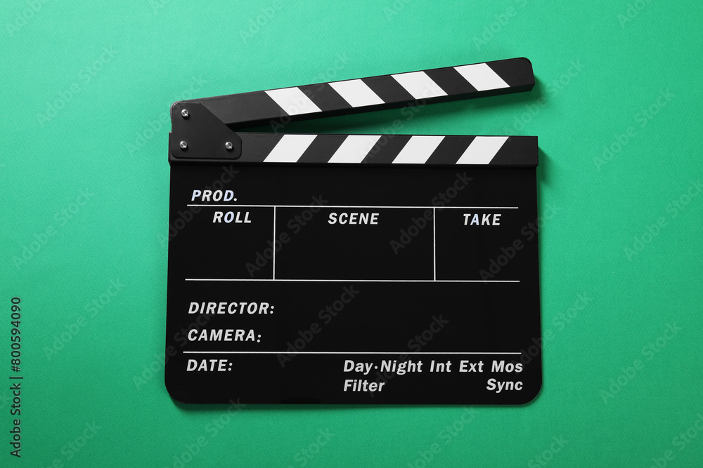 One clapperboard on green background, top view