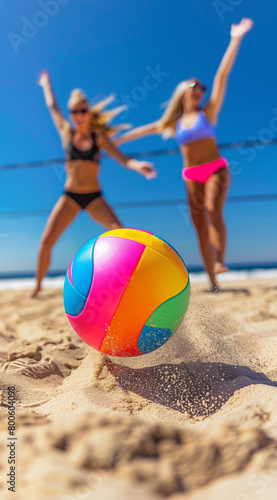 Beach Volleyball in the summer, volleyball closeup, blurred men, women in bikini background